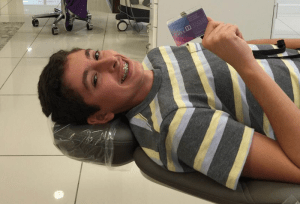 Photo of young patient with his Perfect Perks card